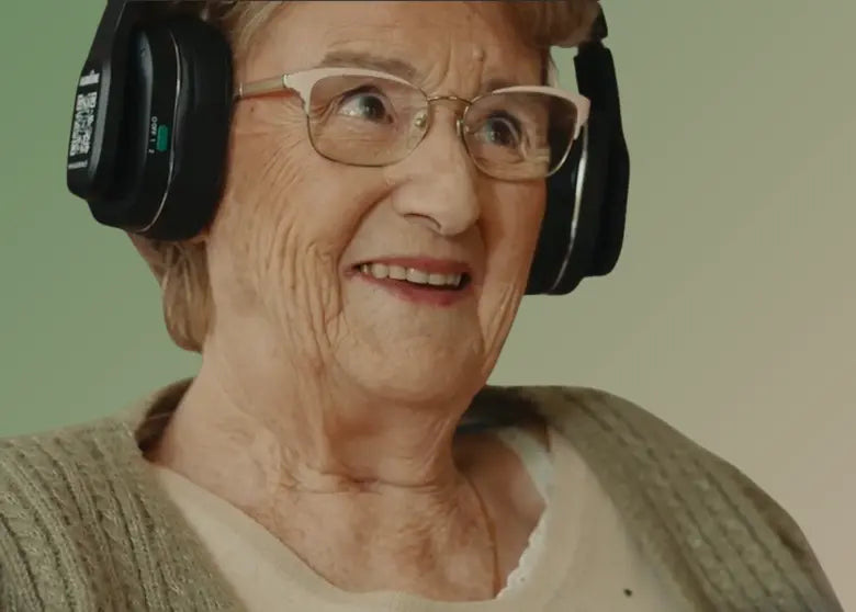 Une dame âgée qui sourit en portant le casque Spokeo